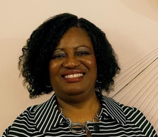 DigitSmart.Online founder Dr. Josephine J. Wiles-Warner, expert in digital side hustles, smiling in a striped blouse against a light background.