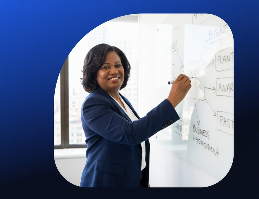 Dr. Josephine Wiles-Warner sketching a business strategy diagram on a whiteboard